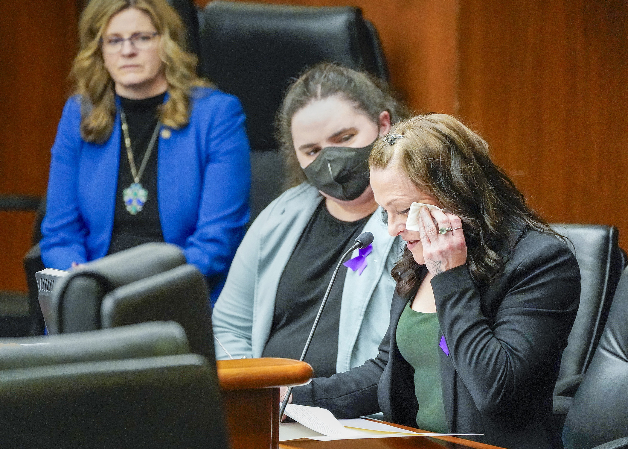 Lauren Franzen, a domestic violence survivor, is comforted by friend Sarah Busch while giving emotional testimony Thursday to the House Public Safety Finance and Policy Committee on HF3398. (Photo by Andrew VonBank)